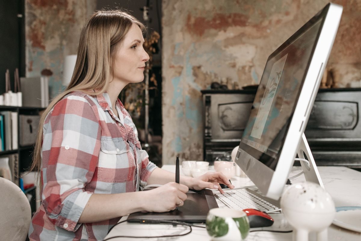A business owner working through her numbers on a large screen